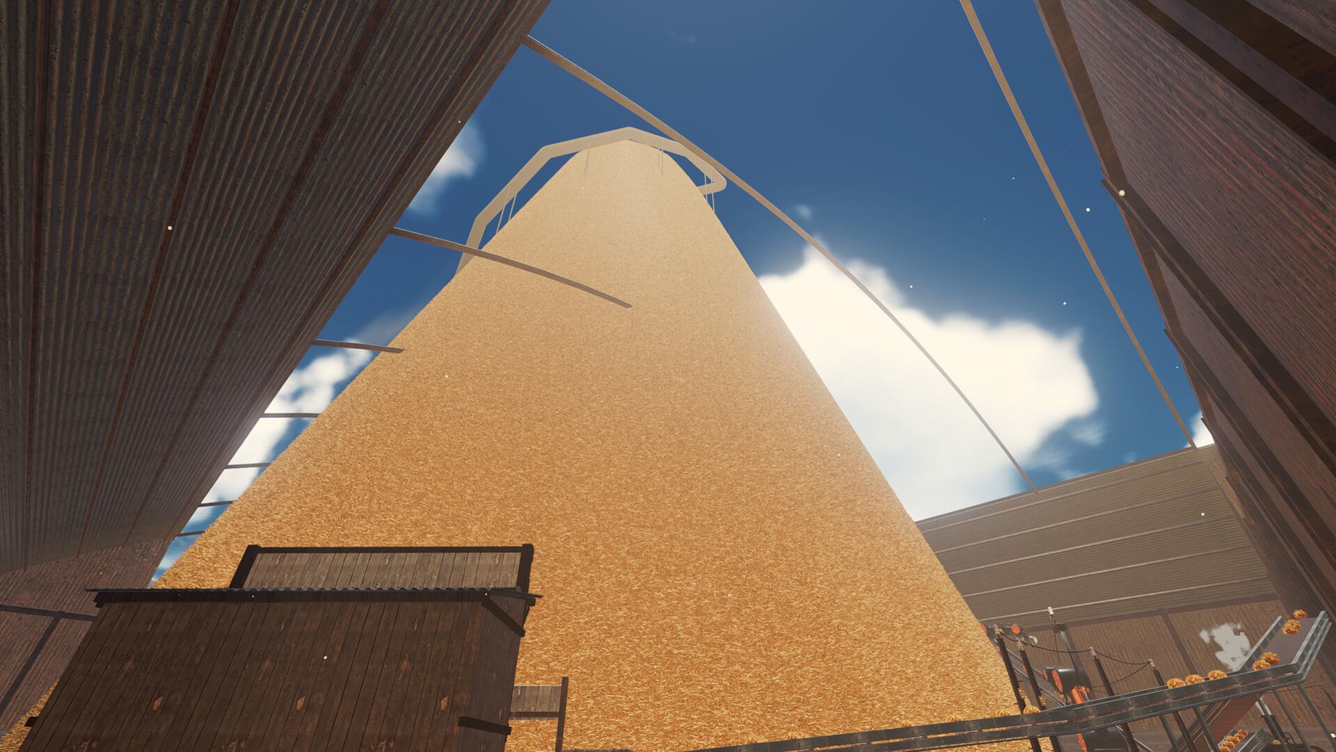 Looking up at a haystack taller than the warehouse around it